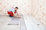 Handyman Laying Down Laminate Flooring Boards Stock Photo