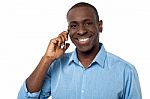 Happy African Guy Attending A Phone Call Stock Photo