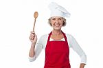 Happy Aged Chef Holding Wooden Spoon Stock Photo