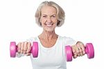 Happy Aged Woman Exercising Stock Photo