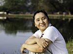 Happy Asian Woman In The Park Stock Photo