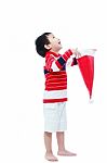 Happy Boy Hold Santa Hat  On White Background Stock Photo