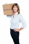 Happy Business Lady With A Box On Her Shoulder Stock Photo