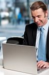 Happy Businessman Working On Laptop Stock Photo