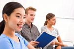 Happy Businesswoman With Her Colleagues In Office Stock Photo