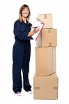 Happy Delivery Woman Preparing An Invoice Stock Photo