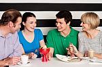 Happy Family Of Four In Restaurant Stock Photo