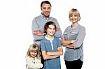 Happy Family Posing With Arms Crossed Stock Photo