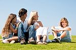 Happy Family Relaxing In Garden Stock Photo