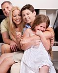 Happy Family Sitting In Straight And Having Fun Stock Photo