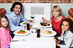 Happy Family Together In A Restaurant Stock Photo