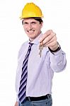 Happy Male Builder Offering New House Keys Stock Photo