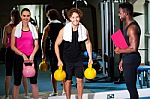 Happy Man And Woman Lifting Kettlebell Stock Photo