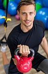 Happy Man Doing Stretching Exercises In A Health Club Stock Photo