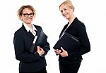 Happy Middle Aged Business Females Holding Files Stock Photo