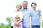 Happy Parents With Their Kids, Outdoors Stock Photo