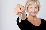 Happy Smiling Woman Showing A Key Stock Photo