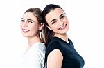 Happy Teen Girls Standing Back To Back Stock Photo