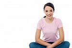 Happy Woman Sitting On Floor Stock Photo