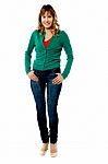 Happy Woman Standing With Hands On Pockets Stock Photo