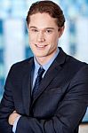 Happy Young Businessman Smiling At The Office Stock Photo