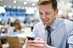 Happy Young Executive Using Smart Phone Stock Photo