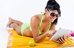 Happy Young Girl With Green Bikini And Digital Table Stock Photo