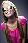 Happy Young  Woman With Sunglasses Looking At The Camera Stock Photo