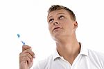 Healthy Male Posing With Toothbrush And Looking Upwards Stock Photo