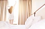 Healthy Woman Stretching In Bed Room And Open The Curtains After Stock Photo