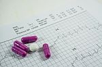 Heap Of Medicine Pills On Cardiogram Grid Paper. Selective Focus Stock Photo