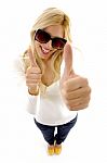 High Angle View Of Smiling Female Model With Thumbs Up Stock Photo