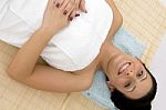 High Angle View Of Smiling Woman Ready To Take Massage Stock Photo