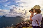 Hiker Taking Photo At Sunset Stock Photo