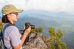 Hiker Teen Girl Holding A Camera For Photography Stock Photo