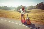 Hippie Girl Hitchhiking Stock Photo