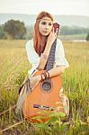 Hippie Girl Playing Guitar On Grass Stock Photo