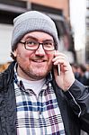 Hipster Traveler Young Man Talking On His Smartphone Stock Photo