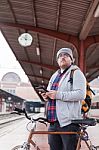 Hipster Young Man Carrying A Bicycle Waiting At Train Station Stock Photo