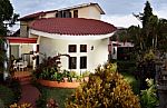 House With Balcony And Garden Stock Photo