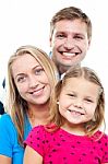 Husband Posing With His Adorable Wife And Daughter Stock Photo