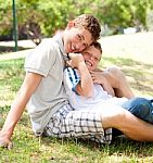 Image Of Brothers Sitting Outdoor Stock Photo