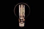 Incandescent Light Bulb On Black Background Stock Photo