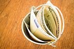 International Currencies Bank Note In The Bucket Stock Photo