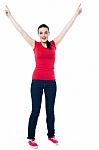 Joyous Female Raising Arms In Excitement Stock Photo