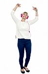 Joyous Middle Aged Woman Dancing To The Beat Stock Photo