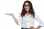 Joyous Woman In Spectacles Posing With Open Palm Stock Photo