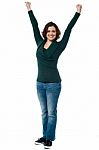 Jubilant Woman With Raised Arms Celebrating Victory Stock Photo