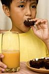 Kid Eating Brownies Stock Photo