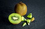 Kiwi Fruit On Black Stone Low Key Light Stock Photo